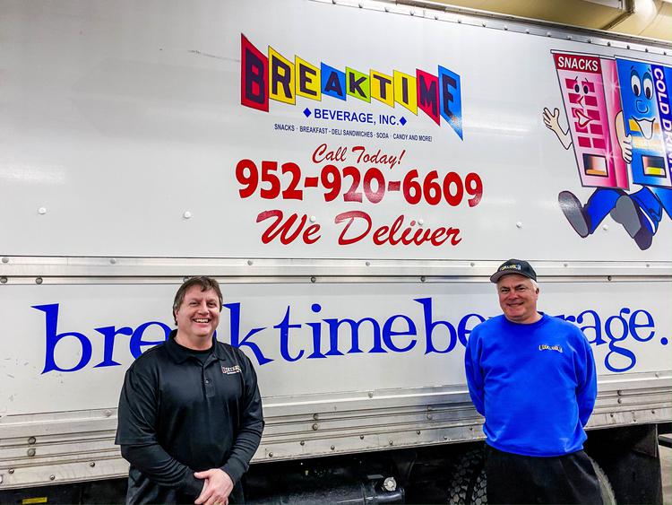 Breaktime Beverage staff standing next to one of their delivery vans. 